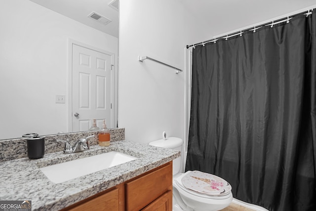 bathroom with vanity, toilet, and a shower with curtain