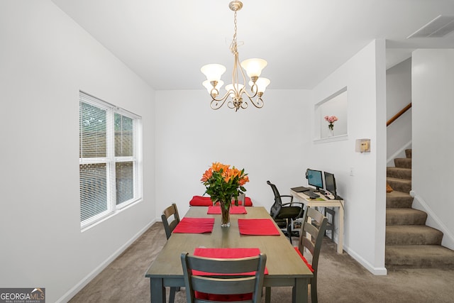 dining room featuring an inviting chandelier and carpet