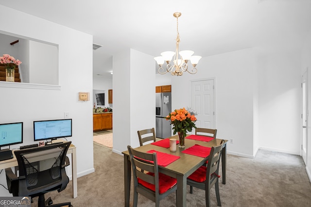 dining area featuring an inviting chandelier and light colored carpet