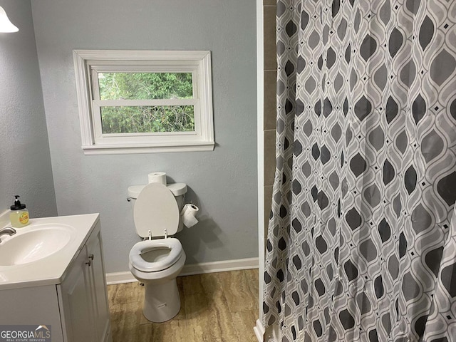 bathroom featuring vanity, hardwood / wood-style floors, toilet, and a shower with shower curtain