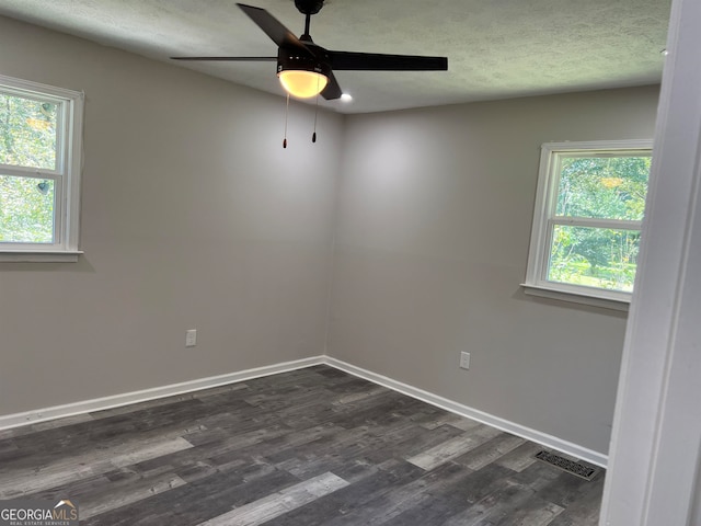 unfurnished room featuring dark hardwood / wood-style floors and ceiling fan