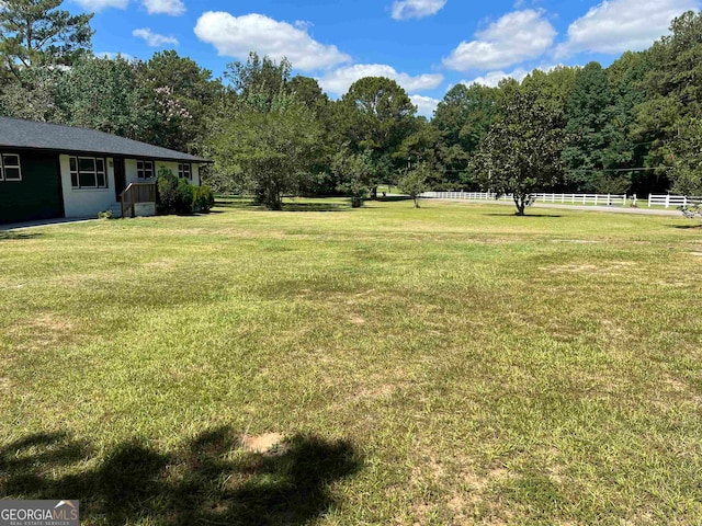 view of yard with a rural view