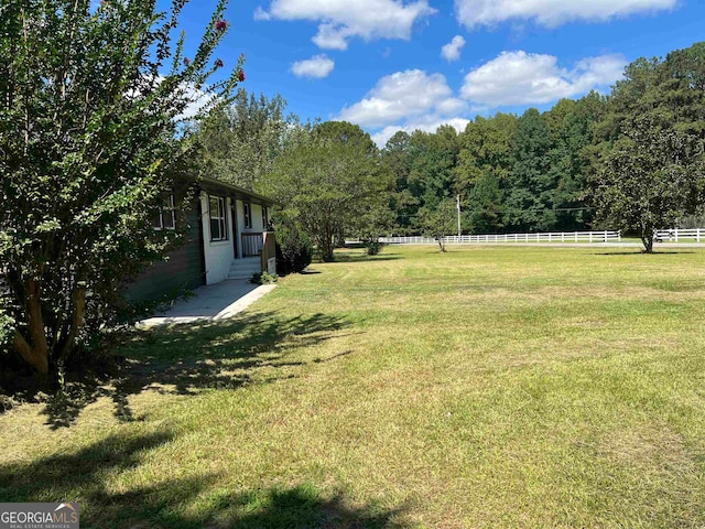 view of yard with a rural view