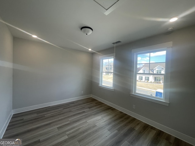 spare room with dark hardwood / wood-style flooring