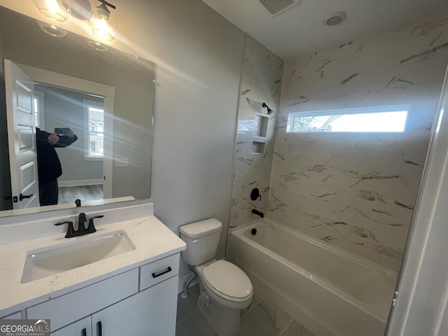 full bathroom with plenty of natural light, toilet, tiled shower / bath, and vanity