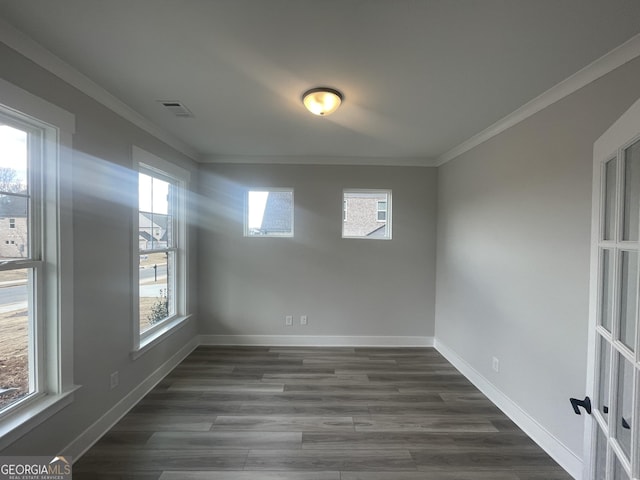 unfurnished room with dark wood-type flooring, plenty of natural light, and crown molding