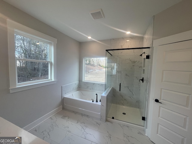 bathroom featuring independent shower and bath