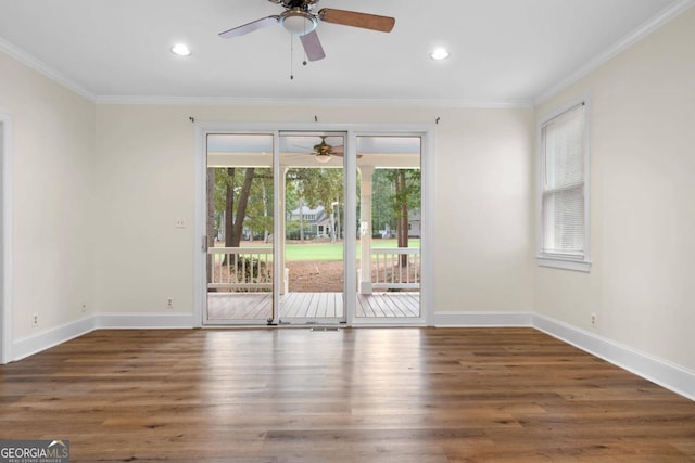 spare room with ceiling fan, dark hardwood / wood-style floors, and ornamental molding