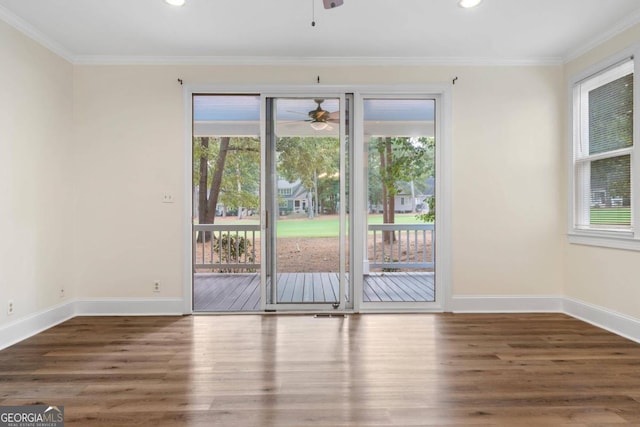 empty room with ceiling fan, crown molding, and dark hardwood / wood-style flooring