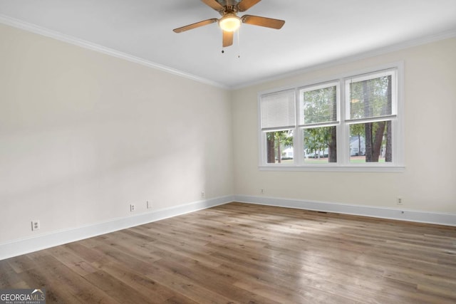 spare room featuring ceiling fan, crown molding, and dark wood-type flooring