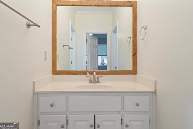 bathroom featuring crown molding and vanity