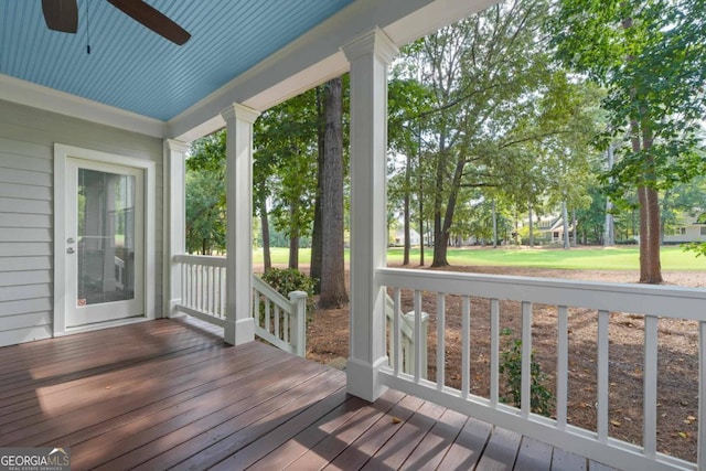 wooden terrace featuring ceiling fan