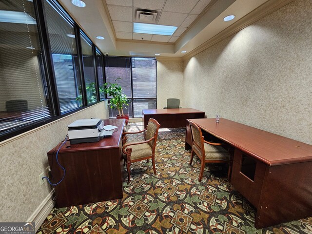 office area featuring a paneled ceiling, ornamental molding, and a raised ceiling