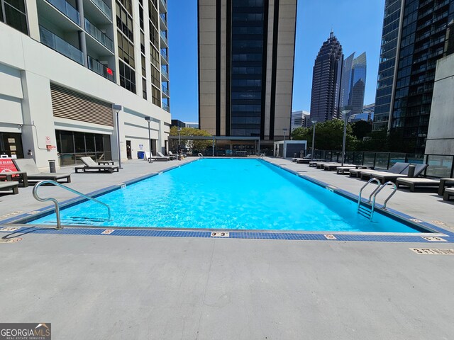 view of swimming pool featuring a patio area