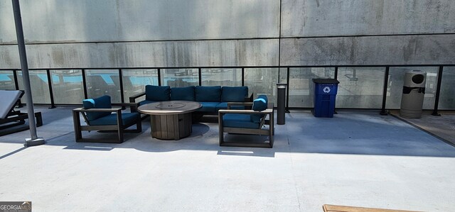 view of patio / terrace with an outdoor living space with a fire pit