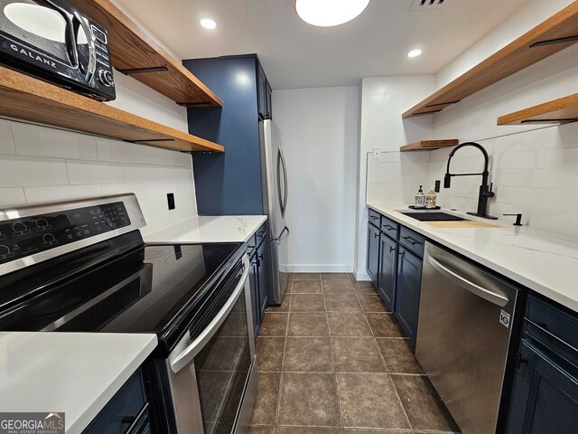 kitchen featuring stainless steel appliances, blue cabinets, tasteful backsplash, and sink