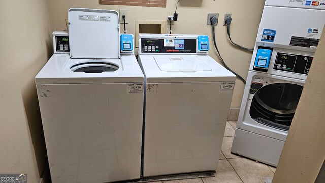 washroom with light tile patterned floors and washer and dryer