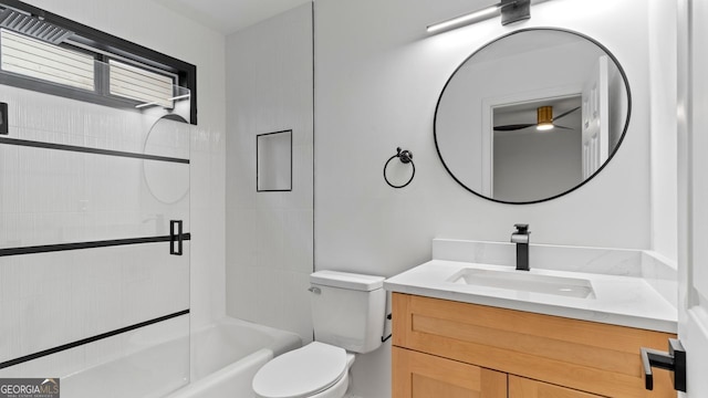 full bathroom with tiled shower / bath combo, vanity, and toilet