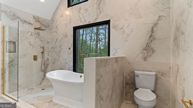 bathroom with tile walls, shower with separate bathtub, vaulted ceiling, and toilet