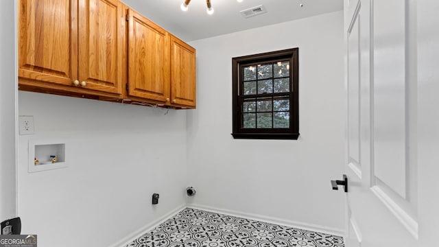 laundry area featuring washer hookup and cabinets