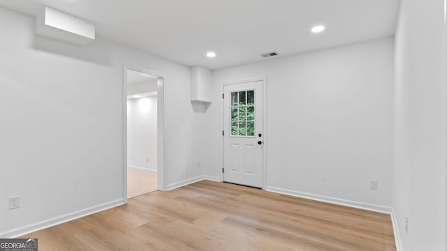 foyer entrance with light hardwood / wood-style floors