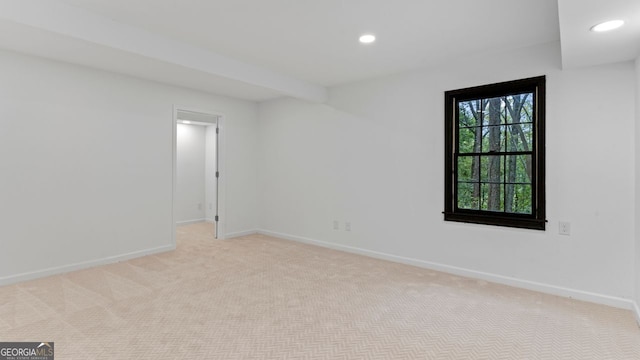 unfurnished room featuring light carpet