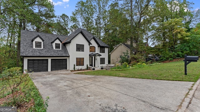 view of front of house with a garage and a front lawn