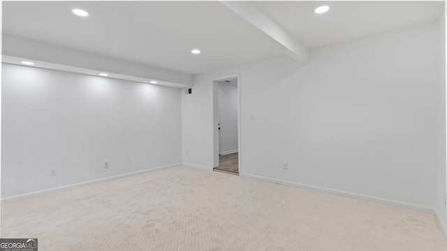 carpeted spare room with beamed ceiling