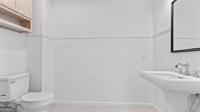 bathroom featuring toilet and tile patterned floors