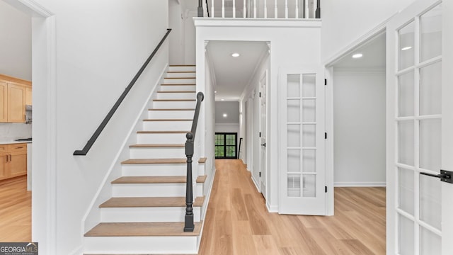 stairway with hardwood / wood-style floors