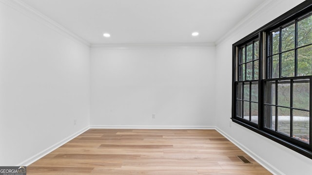 unfurnished room featuring light wood-type flooring and crown molding