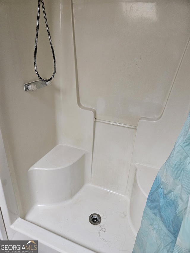 bathroom with a shower with shower curtain