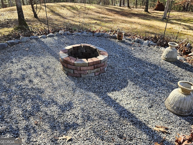 view of yard featuring an outdoor fire pit