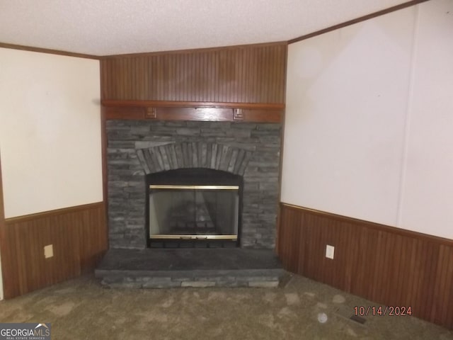 interior details featuring a fireplace, carpet, crown molding, and wood walls