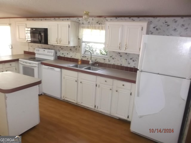 kitchen featuring white cabinets, white appliances, light hardwood / wood-style flooring, and sink