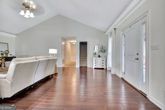 entrance foyer with ornamental molding, lofted ceiling, ceiling fan, and dark hardwood / wood-style flooring