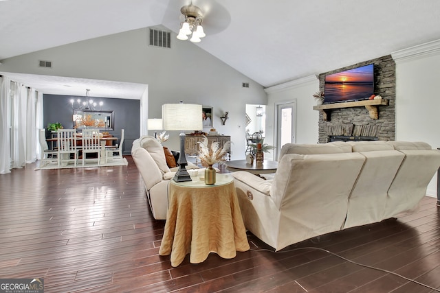 living room with ceiling fan with notable chandelier, a fireplace, dark wood-type flooring, and high vaulted ceiling