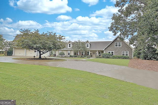 view of front of house featuring a garage and a front lawn