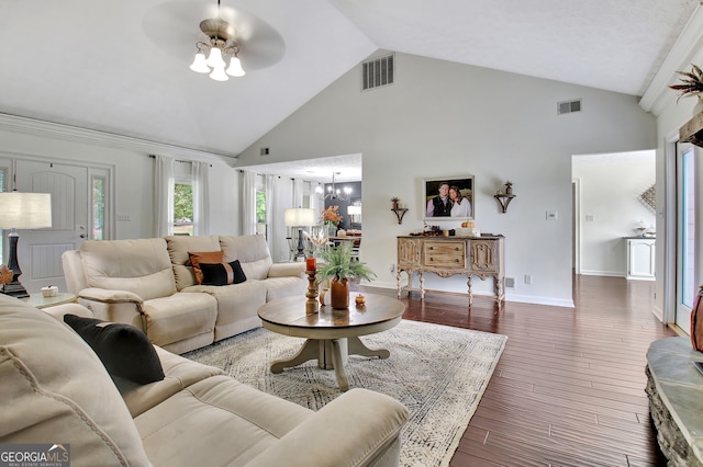 living room featuring ceiling fan with notable chandelier, dark hardwood / wood-style flooring, and high vaulted ceiling