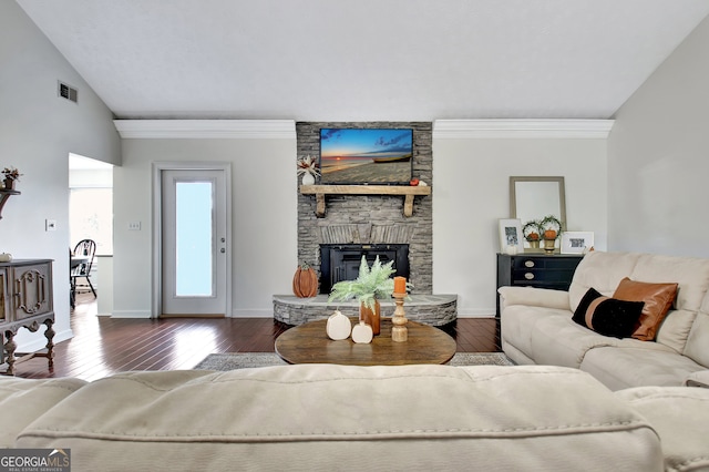 living room featuring a stone fireplace, crown molding, lofted ceiling, and dark hardwood / wood-style flooring