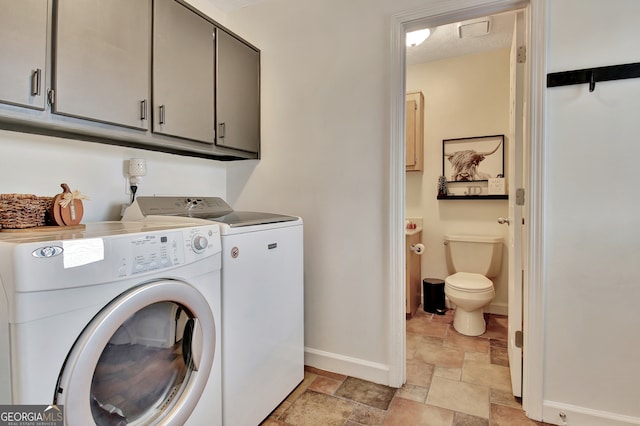 laundry room with separate washer and dryer, cabinets, and a barn door