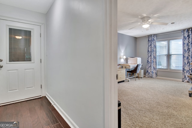 entryway with ceiling fan and dark hardwood / wood-style flooring