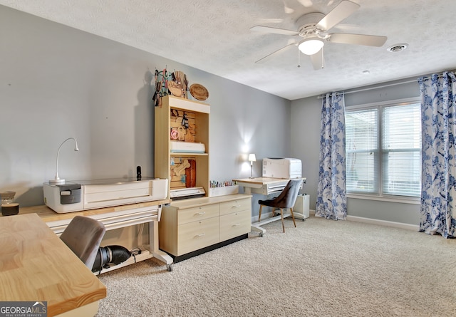 office space with ceiling fan, light colored carpet, and a textured ceiling