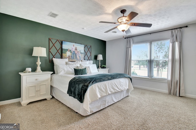 bedroom featuring carpet, a textured ceiling, and ceiling fan