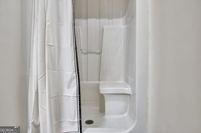 bathroom with a shower with curtain