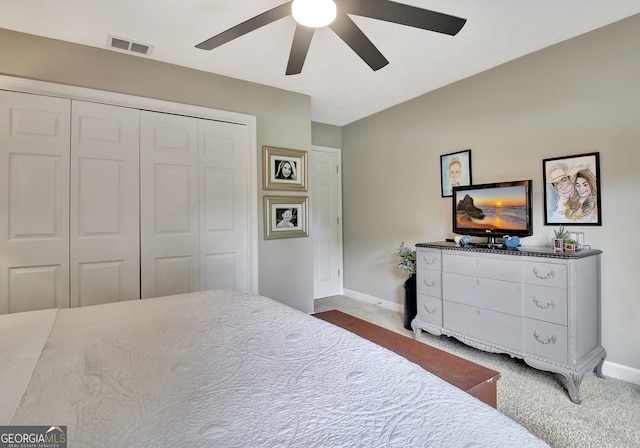 carpeted bedroom featuring a closet and ceiling fan