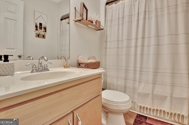 bathroom featuring tile patterned floors, curtained shower, vanity, and toilet