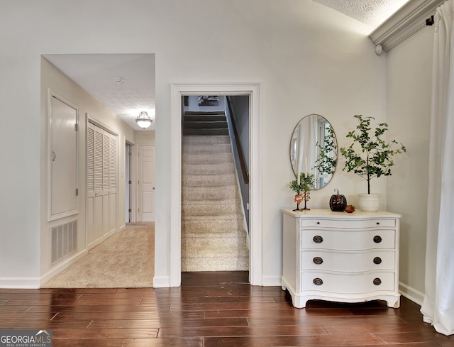 foyer with a textured ceiling and dark wood-type flooring