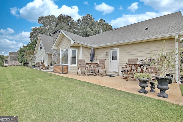 back of property with a patio and a yard