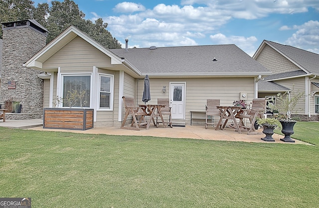 rear view of property with a lawn and a patio area